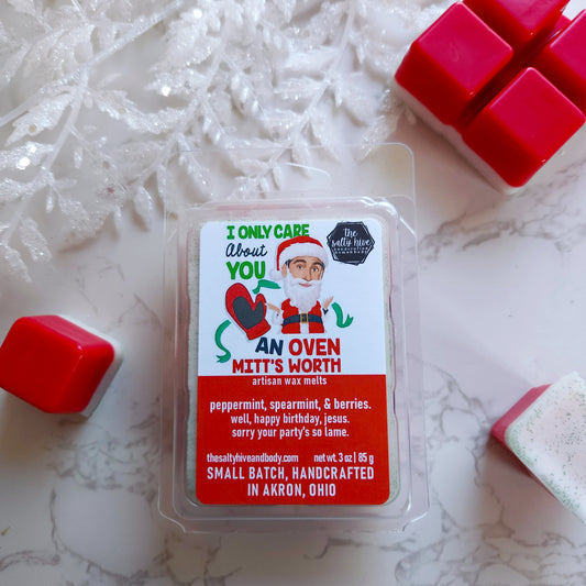 Wax melt package with Santa Claus design on a white surface with red wax melts. michael scott as santa from the office