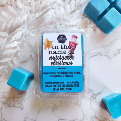 Wax melts packaging with 'In the name of Nutcracker Christmas' label on a wooden surface. the office tv show christmas