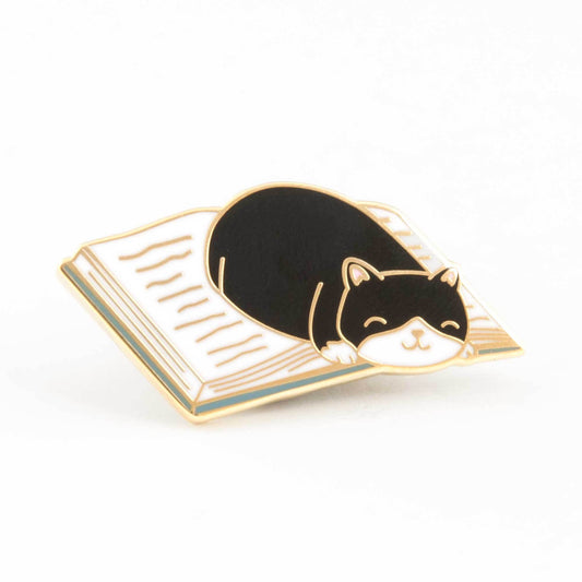 cat curled up in a good book enamel pin - the salty hive